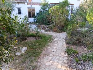 a garden path in front of a house at Natalie's Garden Cottage, in McGregor +8 photos