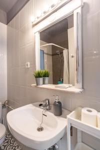 a white bathroom with a sink and a mirror at CHiC APARTMENT in Tossa de Mar
