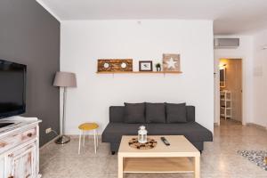 a living room with a couch and a coffee table at CHiC APARTMENT in Tossa de Mar