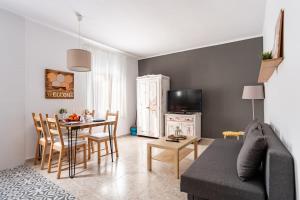 a living room with a couch and a table at CHiC APARTMENT in Tossa de Mar +15 photos