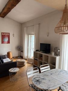 a living room with a table and a couch at Studio 1er Consul in Ajaccio