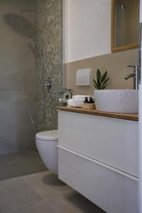 a bathroom with a toilet and a sink and a shower at GUESTHOUSE Kastel Novi in Kaštela +7 photos