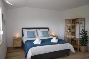 a bedroom with a bed with two towels on it at GUESTHOUSE Kastel Novi in Kaštela