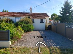 a driveway in front of a house with a parking sign at le Pressoir Doretz in Arthon-en-Retz +3 photos