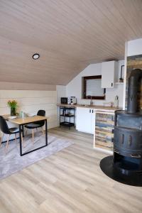 a kitchen with a table and a stove in a room at Apartments Hana Bled in Bled