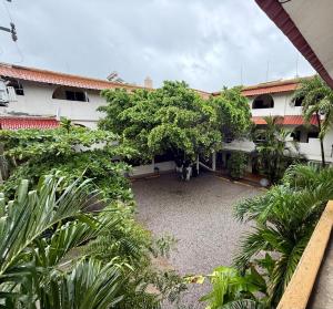 an outside view of a building with trees and a courtyard at Mega Suite en Hotel Cosmos in Tamasopo
