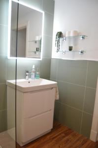 a bathroom with a white sink and a mirror at Ness View Apartment in Inverness +38 photos