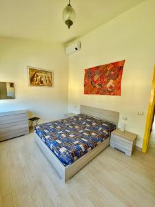 a bedroom with a bed and a painting on the wall at Xerxe's House in Varenna +4 photos