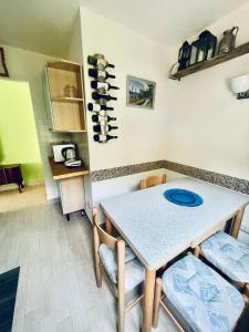 a kitchen with a table and chairs and wine bottles at Xerxe's House in Varenna