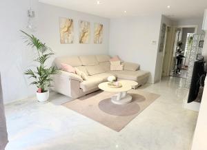 a living room with a couch and a table at Apartamento Golf Valle Romano in Estepona