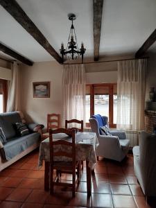 a living room with a table and chairs at Apartamentos Turísticos Rural Los Tinaos in Bubión