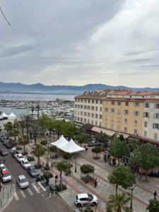 a city with cars parked in a parking lot at Studio 1er Consul in Ajaccio