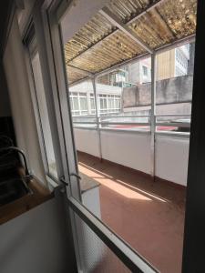an open window of a building with a view of a street at O Repouso in Lalín