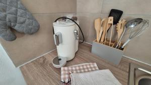 a kitchen counter with a food processor on the floor at Wildstein - Ferienwohnungen in Bayrischzell
