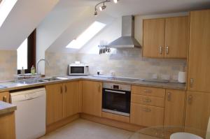 a kitchen with a sink and a stove top oven at Ness View Apartment in Inverness