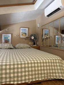 a bedroom with a bed with a checkered blanket at Studio 1er Consul in Ajaccio