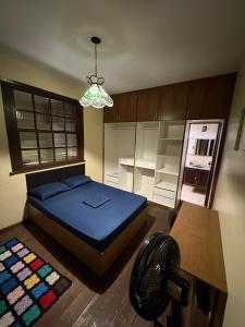 a bedroom with a bed and a chandelier at NóIS DE CASA HOSTEL & SUÍTES in Belo Horizonte