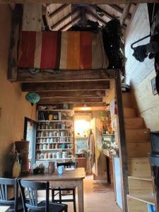 a room with a table and a large bag on the ceiling at Le Temps du Coeur - TYNID in Saint-Ganton
