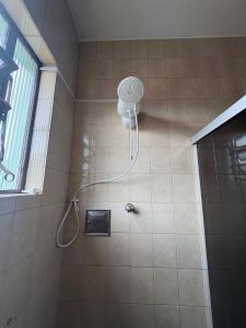 a shower with a shower head in a bathroom at NóIS DE CASA HOSTEL & SUÍTES in Belo Horizonte +77 photos