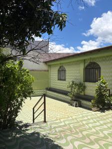 a green building with windows on the side of it at NóIS DE CASA HOSTEL & SUÍTES in Belo Horizonte