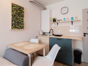 a small kitchen with a small table and a sink at Apartament Antoninek in Poznań