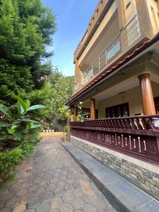 a house with a stone walkway next to a building at Elowen Villa in Mananthavady +9 photos