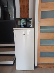 a small refrigerator in a room next to a door at Studio en Luberon in La Bastidonne