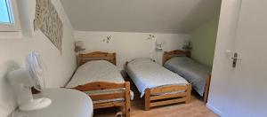 a room with three bunk beds and a table at La tour de Plumont in Dole