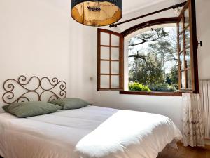 a bedroom with a bed and an open window at Yacumama Guesthouse in Soorts-Hossegor