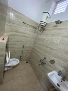 a bathroom with a toilet and a sink at Nahta's Farm in Indore +12 photos