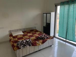 a bedroom with a bed and a large window at Nahta's Farm in Indore