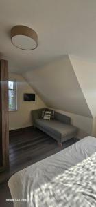 a bedroom with a bed and a ceiling at Ferienhaus-Windflüchter Hirtenweg 3B in Zingst