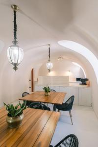 a dining room with a wooden table and chairs at AmalfiRa Luxury Seaview Rooftop in Amalfi