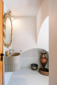 a bathroom with a sink and a mirror at AmalfiRa Luxury Seaview Rooftop in Amalfi +56 photos