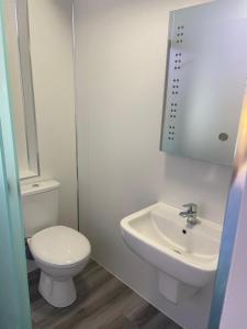 a white bathroom with a toilet and a sink at The Old Printworks, Kirkwall in Orkney +12 photos