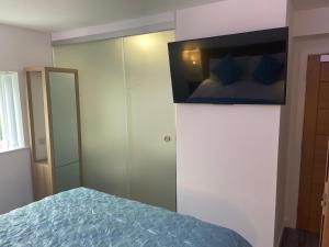 a bedroom with a bed with blue sheets and a mirror at The Old Printworks, Kirkwall in Orkney