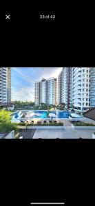 two pictures of a city with tall buildings at MeCasa in Mactan Island