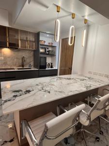 a kitchen with a large marble table and chairs at MeCasa in Mactan Island