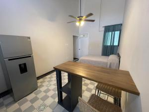 a dining room with a table and a refrigerator at Apartamento 25 Centrico Chapala in Chapala +5 photos