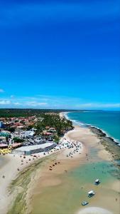 an aerial view of a beach with umbrellas at Flat StudioMar - beira mar até 4 p - pé na areia in Coruripe