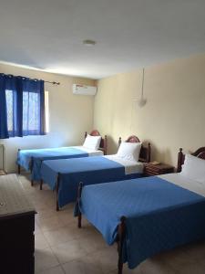 a group of four beds in a room at Residencial Monte Sintinha in Espargos
