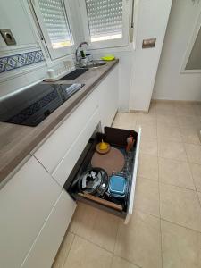 a kitchen with an open drawer in the floor at Taína La Encina in Vícar