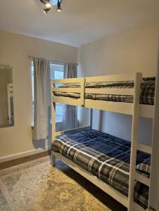 a bedroom with two bunk beds and a window at London Heathrow Accommodation in Hillingdon +6 photos