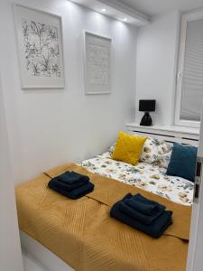 a bedroom with a bed with blue towels on it at Luksusowy Apartament Giżycko in Giżycko +11 photos