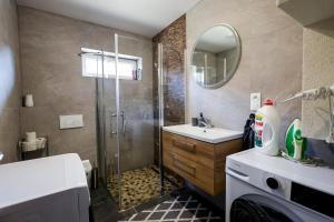 a bathroom with a shower and a sink at Villa de Calma Samorin in Šamorín