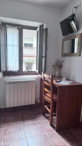 a room with a desk and a table with a chair at Casa Cuevas in Caín +89 photos