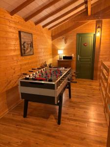 a room with a foosball table in a room at Le ptit Sabot in Corcieux