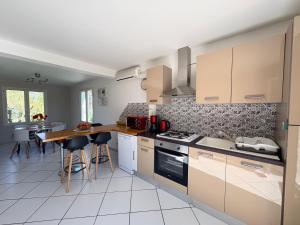 a kitchen with a counter and a table with chairs at Mon calme in Arques-la-Bataille