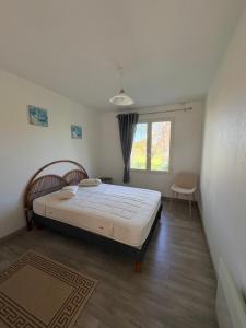 a bedroom with a large bed and a window at Mon calme in Arques-la-Bataille