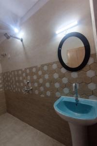 a bathroom with a sink and a mirror on the wall at Kadamba Bnb Homestay in Kurseong
